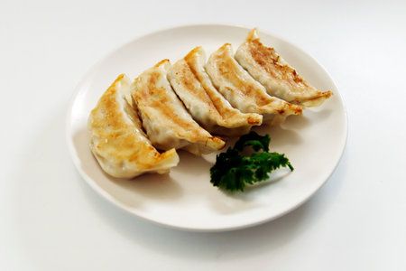 Freshly baked dumplings with plenty of gravy on the tableの写真素材