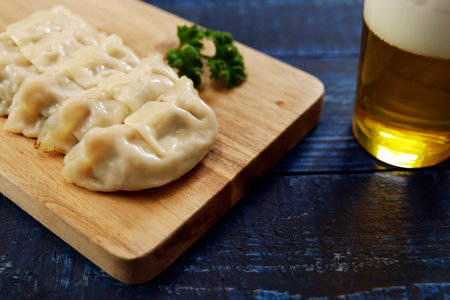 Freshly baked dumplings with plenty of gravy on the tableの写真素材