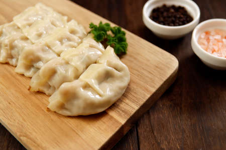 Freshly baked dumplings with plenty of gravy on the tableの写真素材