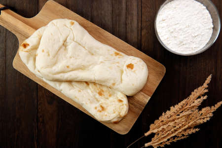 Nan made from wheat to eat with Indian curry on the tableの写真素材