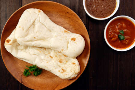 Nan made from wheat to eat with Indian curry on the tableの写真素材