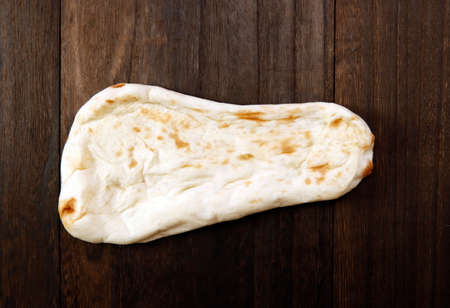 Nan made from wheat to eat with Indian curry on the table