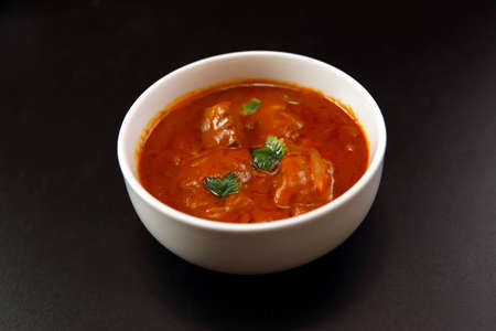 Indian chicken curry roux like tomato soup on the tableの写真素材