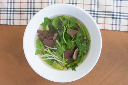 Chinese clear soup with boiled entrails and vegetables.