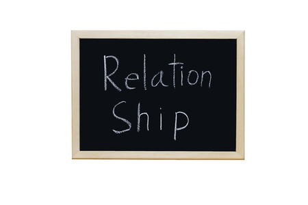 Relationship written with white chalk on blackboard.の写真素材