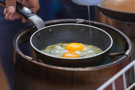 Frying scrambled eggs in fatの写真素材