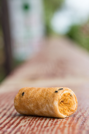 Crispy roll with dried shredded pork on a wood barの写真素材
