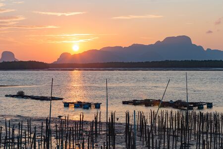 Landscape of riverside with mountains behind during the sunrise.の写真素材
