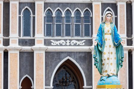 The Blessed Virgin Mary,mother of Jesus on the blue sky, in front of the Roman Catholic Diocese, public place in Chanthaburi, Thailand.の写真素材