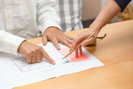 Hands of architect meeting about floor plan in the office.の写真素材