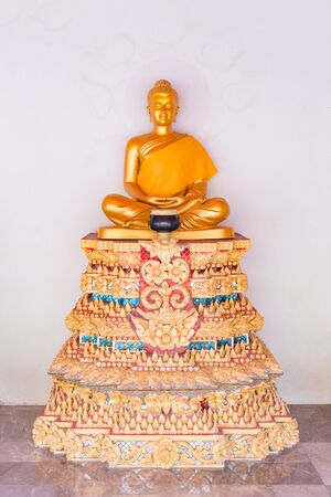 Golden Buddha Statue on the wall in public temple, Thailand.の写真素材