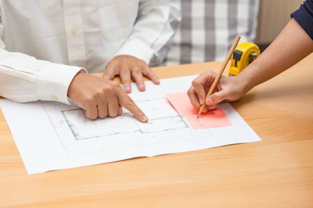 Hands of architect meeting about floor plan in the office.の写真素材