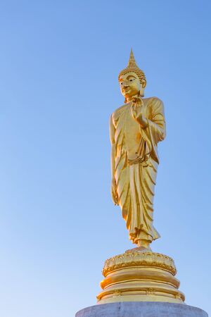 The standing buddha statue on blue sky, located in Chanthaburi, Thailand.の写真素材