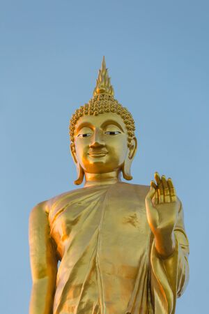 The standing buddha statue on blue sky, located in Chanthaburi, Thailand.の写真素材
