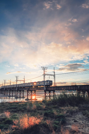 Railway bridge at sunset with beautiful sky and clouds, long exposure