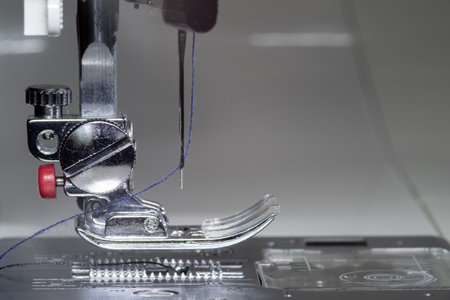 Metallic sewing machine foot. Studio light macro photo