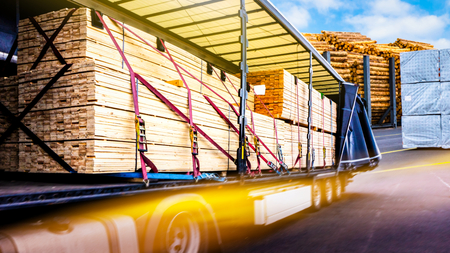 There is a loading for the truck trailer. fastening of freight in the trailer. Truck in unloading in warehouse. Truck on the road. Commercial transport. truck transport containerの写真素材