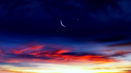 Crescent moon with beautiful sunset background. Generous Ramadan. Light from sky. Religion background.の写真素材