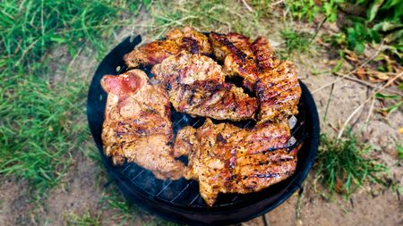 Assorted delicious grilled meat on a barbecue. Selective focus on juicy grilled barbecue grill grade with flame.の写真素材