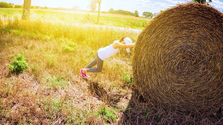 happy childhood. Summer in the country. Round straw bales on field. Summer landscape.