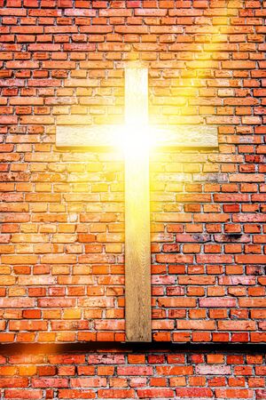 Wooden cross in the wall of the church. The Light of Christ Crucifix. Religion background. The house of God.の写真素材