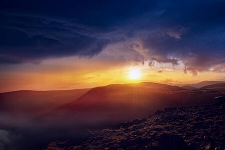 the sun in mountains. Cloud landscape. Dramatic sunset. background sky at sunset and dawn. Background tranquility of the nature. beautiful sky.の写真素材