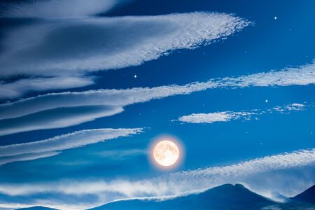 Full moon in the mountains. Beautiful night. High mountain peak covered with snow in winter. Cloud landscape. . Religion backgroundの写真素材
