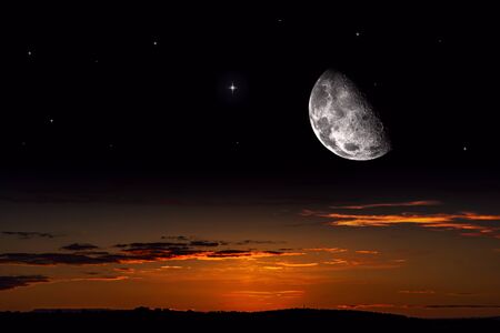 Moon against the background of a bright cloud. Half moon. Crescent moon with beautiful sunset background. Generous Ramadan.の写真素材