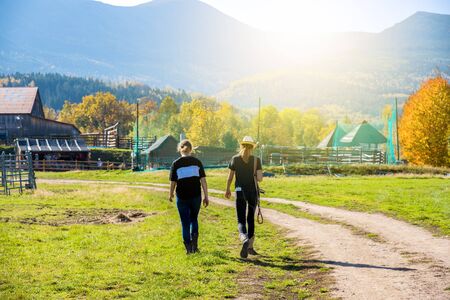 Beautiful cowboy girls. Cowboy Scene. Two cowboys go to stablesの写真素材