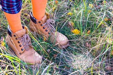 Feet in yellow boots. Autumn walk. ridiculous photo