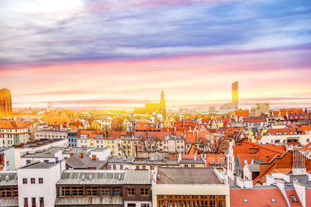 The city of Wroclaw, a beautiful view of the bright roofs of the houses. Old town from the height of bird flight, at dawn or sunsetの写真素材
