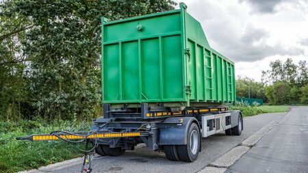 Disposal and recycling dumpster. A large, metal, green garbage container and municipal waste,...