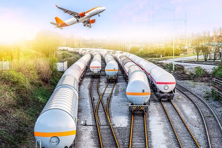 The refuelling aircraft took off over the railway terminal.の写真素材