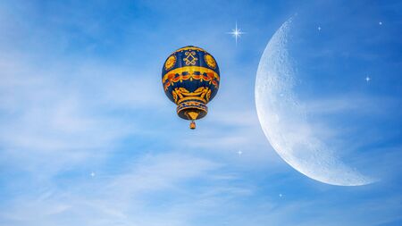 Moon in bright clouds of sunset sun. New moon, moon in the blue sky new moon in the cloudsの写真素材