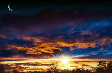 Celestial landscape with sunset of sun and moon.の写真素材