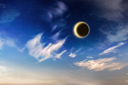 Eclipse of the sun on the blue skyの写真素材