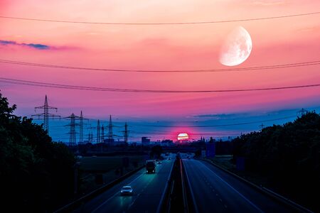 Sunset, moving cars with light turned on. Night scene on the highwayの写真素材