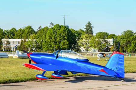 blue airplane on the airfield ready to fly into the sky