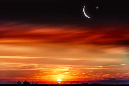 New moon. Prayer time. Generous Ramadan. Sunset in the clouds and new moon. tranquility of the nature backgroundの写真素材