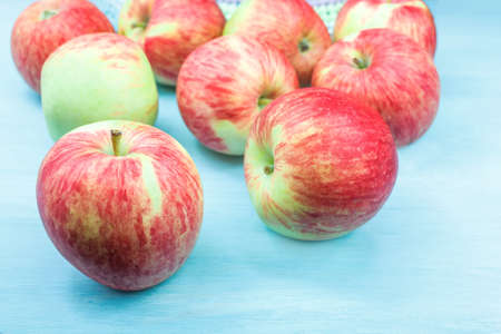 apples with a red barrel on the table. against a blue background fruit