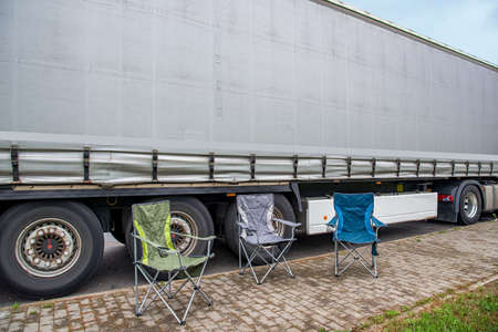 folding chairs for rest near trucks, weekend at workの写真素材
