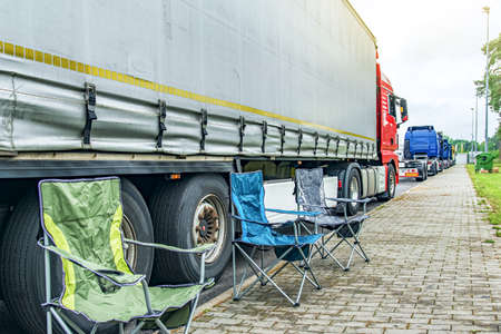 folding chairs for rest near trucks, weekend at workの写真素材