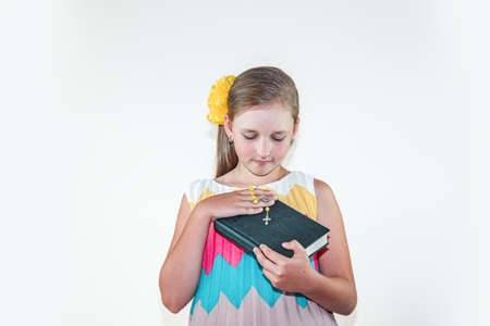 The Bible is in the hands of a child, religious upbringingの写真素材