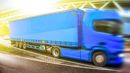 Motion blurred trucks on highway. Transportation. truck on the road, delivery of goods in Europeの写真素材