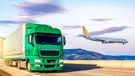 The plane is landing flying over the road with a truck