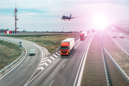 the plane flies over the truck. Logistics and transportationの写真素材