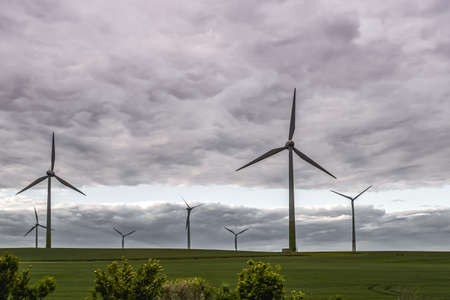 Wind turbines farm at sunset, windy and cloudy weather. wind generator
