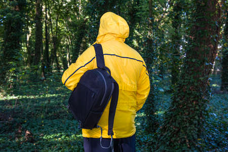 Traveler - man, trips to the forest with a backpack in autumn or spring