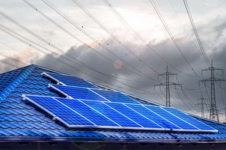 Solar panel on the roof, electrical wires on the rear background, alternative energy backgroundの写真素材