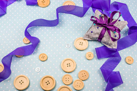 buttons on the table with pins and ribbons, Sewing accessories dressmaker